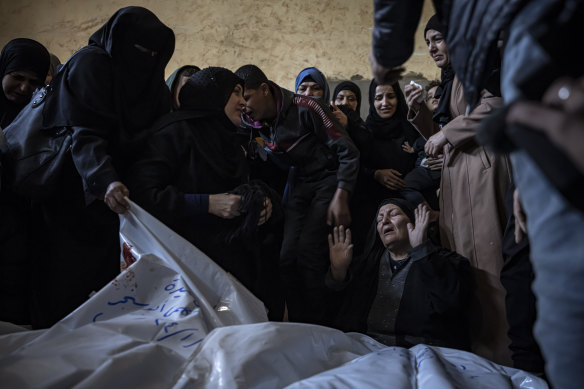 In Rafah, southern Gaza, on Friday, members of the Abu Sinjar family mourn their relatives killed in the Israeli bombardment of the Gaza Strip. Other photographs show several children were among at least seven dead.