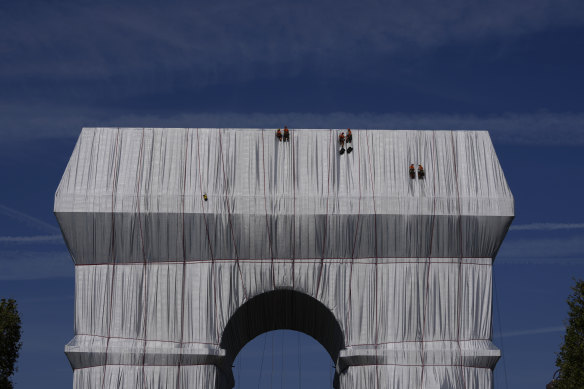 Workers finish wrapping the Arc de Triomphe in Paris