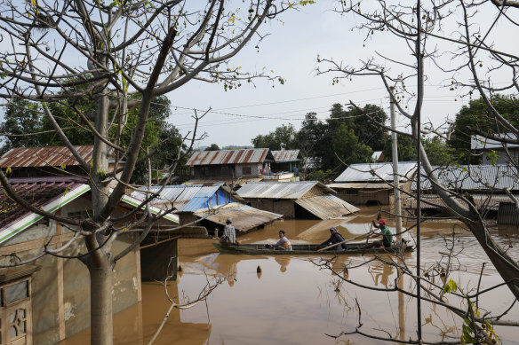 Residents travel by boat through a flooded road in Naypyitaw, Myanmar, on Sunday.