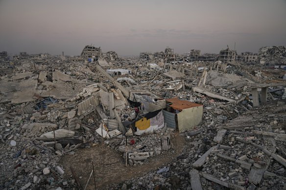A makeshift tent stands amid widespread devastation in Gaza City in November.