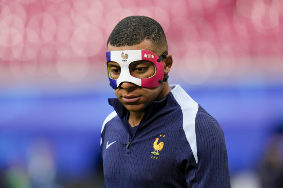 France’s Kylian Mbappe wears a face mask during a training session in Leipzig, Germany after breaking his nose in his side’s first Euros match against Austria.