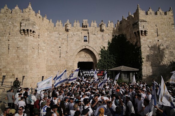 Israelis dance and wave national flags on Monday during an annual march celebrating the 1967 capture of East Jerusalem.