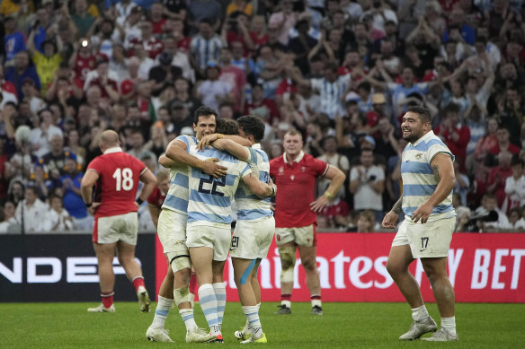 Argentina players celebrate after defeating Wales in the Rugby World Cup quarterfinal match.