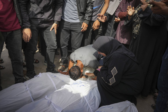 Palestinians mourn their relatives who were killed in an Israeli airstrike in Nuseirat.