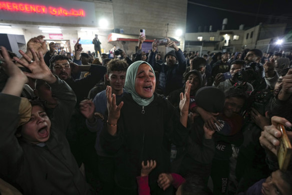 Palestinians celebrate the announcement of a ceasefire deal between Hamas and Israel in Deir al-Balah, central Gaza Strip.
