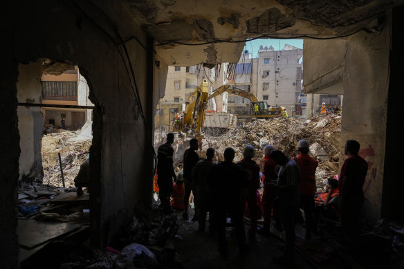 Emergency workers use excavators to clear the rubble at the site of Friday’s Israeli strike in Beirut’s southern suburbs, Lebanon.