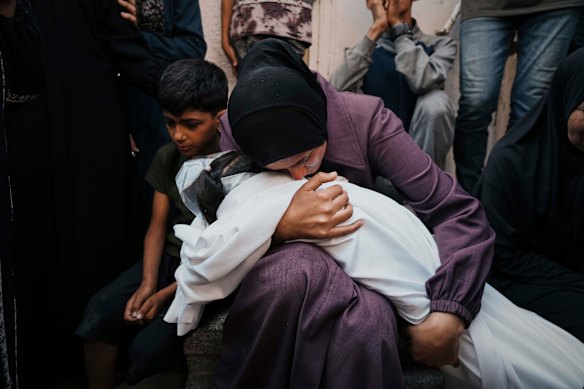 A Palestinian woman embraces the body of her eight-year-old daughter, Mayar Abu Odeh, who was killed in an Israeli army strike on Gaza on Wednesday.