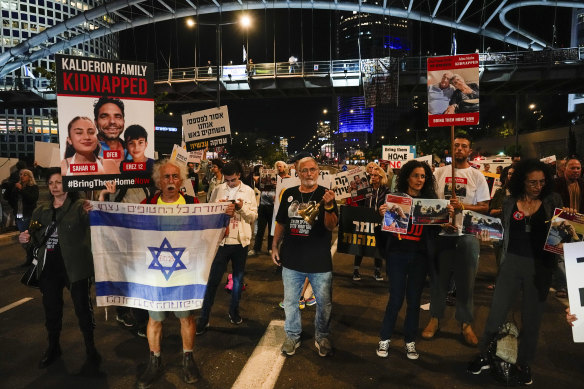 Families and friends of about 240 hostages held by Hamas in Gaza call for Israeli Prime Minister Benjamin Netanyahu to bring them home during a demonstration in Tel Aviv on Tuesday.