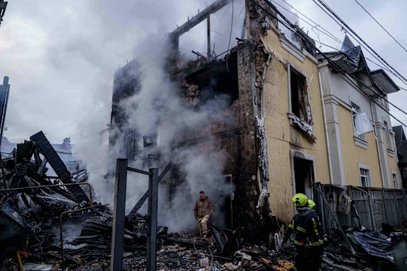 A man walks from a house destroyed in a Russian strike.