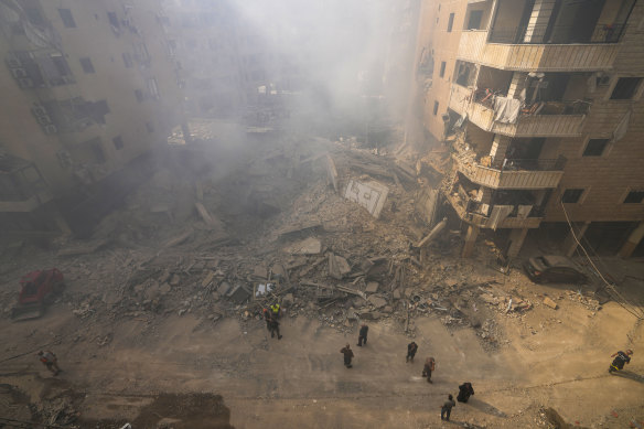 Rescuers examine rubble in Beirut.