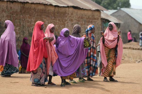 Parents wait for news about their kidnapped children at the LEA Primary and Secondary School in Kuriga, on Saturday.