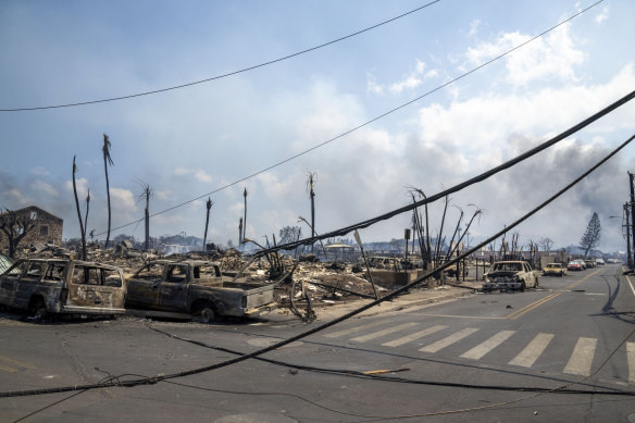 What appear to be power lines down at the scene at one of Maui’s tourist hubs which was reduced to wreckage by the fires.