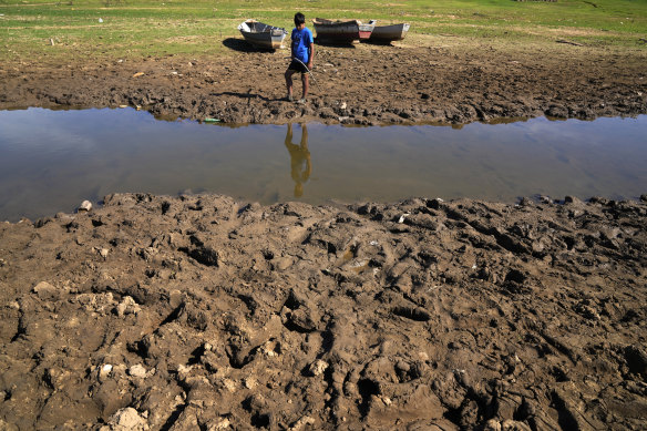 Cristopher Benegas, 12, fishes in what’s left of the Payagua stream, a tributary of the Paraguay River, in Chaco I, Paraguay, on Friday.