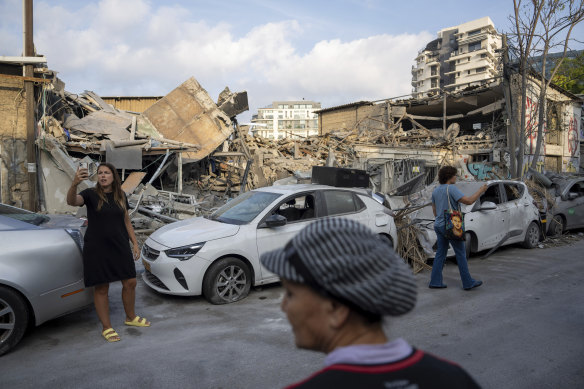 Israelis inspect the rubble of a building in Tel Aviv following a rocket strike from the Gaza Strip. 