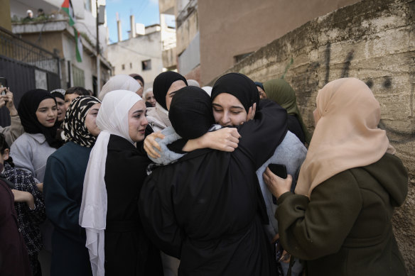 Dunya Shtayyeh, centre, a former Palestinian prisoner who was released from an Israeli prison as part of a cease-fire deal between Israel and Hamas, is greeted by friends and family members in the West Bank village of Salem.