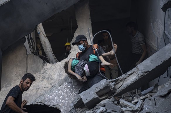 Palestinians evacuate wounded from a building destroyed in Israeli bombardment in Khan Younis, Gaza Strip.