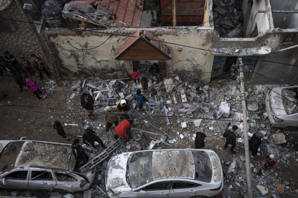 Palestinians looking at the destruction after an Israeli airstrike in Rafah, Gaza Strip.