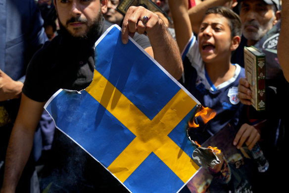 Hezbollah supporters chant slogans as they burn representations of the Swedish flag at a rally denouncing the desecration of the Koran, after Friday prayers in the southern Beirut suburb of Dahiyeh, Lebanon, on Friday.