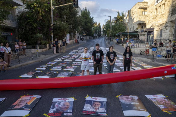 Families and friends of hostages held by Hamas in Gaza display 107 pictures of hostages as they protest outside the Prime Minister Benjamin Netanyahu’s residence in Jerusalem.