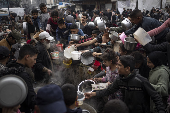 Palestinians line up for a free meal in Rafah, Gaza Strip, on Thursday.