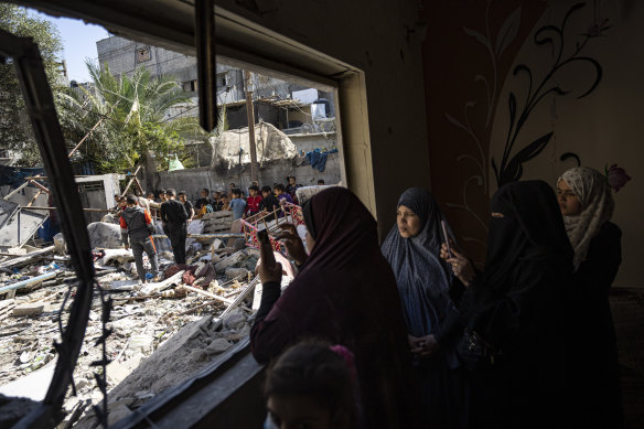 Members of the Abu Draz family inspect their house after it was hit by an Israeli airstrike in Rafah on Thursday.