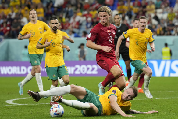 Harry Souttar slides in for another tackle against Denmark’s Kasper Dolberg.