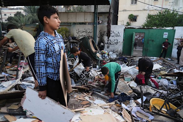 Palestinians inspect the damage at school used as a shelter by displaced residents that was hit by Israeli military strike in Gaza City on Monday.