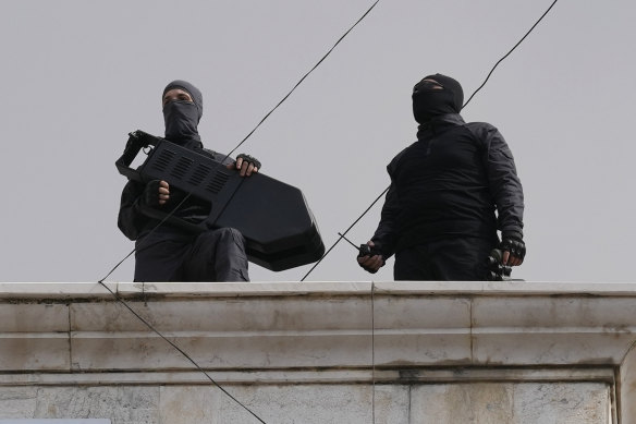 Hezbollah fighters stand guard on a rooftop in a southern suburb of Beirut, Lebanon.