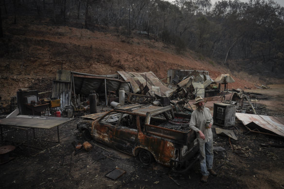 Mark Brooks at the wreckage of his house in the Upper Towgla valley.