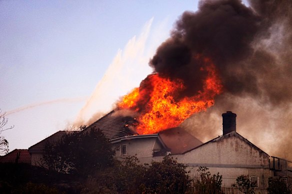 A roof engulfed in flames during a fire in San Juan Capistrano on Friday, October 16.
