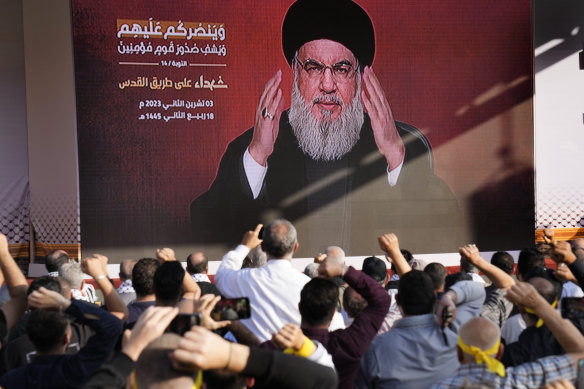 Hezbollah leader Hassan Nasrallah greets his supporters via a video link, during a rally in Beirut, Lebanon.