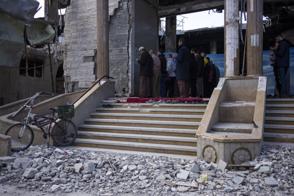Palestinians pray in a damaged mosque following an Israeli strike in Rafah, southern Gaza Strip.