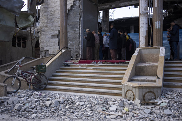 Palestinians pray in a mosque damaged by an Israeli raid on the city of Rafah in the southern Gaza Strip.