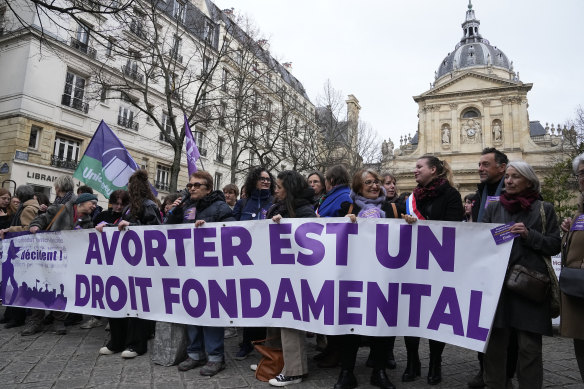 Pro-abortion rights activists hold banner reads “abortion is a fundamental right” during a recent rally for abortion rights in Paris.