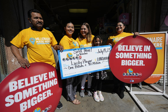 (From left) The owner of Las Palmitas Mini Market, Navor Herrera, with family members Sarai Palacios, his wife Maria Menjivar, Natalie Palacios, 9, and stepdaughter Angelica Menjivar outside the store in downtown Los Angeles, 