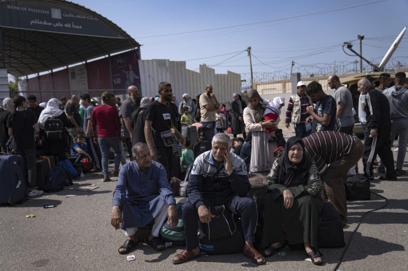 Palestinians wait to cross into Egypt at the Rafah border crossing in the Gaza Strip.