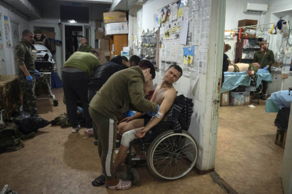 Military medics give first aid to wounded Ukrainian soldiers near Bakhmut, Ukraine, in January.