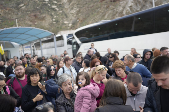 People wait for the ferry to arrive at Santorini on Monday.