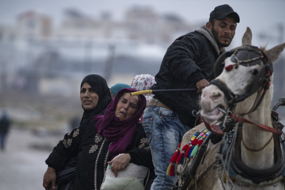 Palestinians arrive in the southern Gaza town of Rafah after fleeing an Israeli ground and air offensive in the nearby city of Khan Younis.