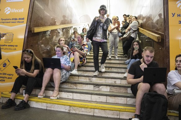 People take cover at a metro station during a Russian rocket attack in Kyiv.