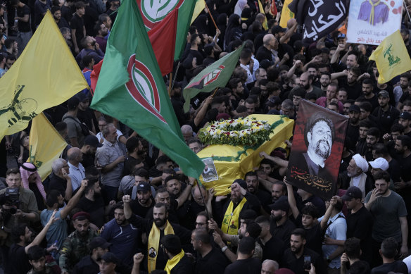 Hezbollah fighters carry a coffin of one of the people killed when pagers exploded in Lebanon.