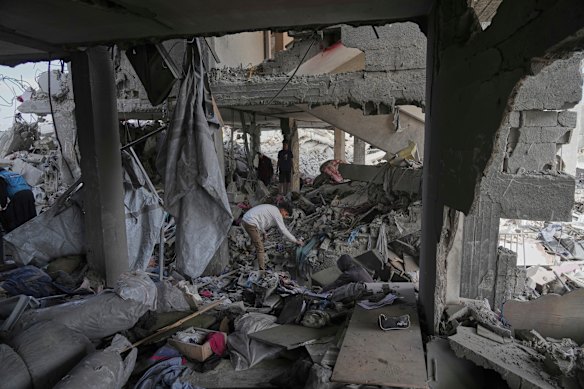 Palestinians look at the damage after an Israeli army airstrike in Beit Lahia, northern Gaza Strip.