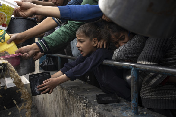 Palestinians line up for a free meal in Rafah.