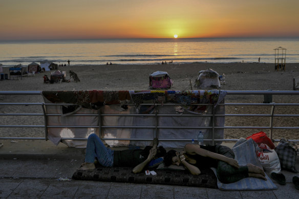 Men sleep at the Ramlet al-Baida public beach after fleeing the Israeli airstrikes in Dahiyeh, Beirut, Lebanon, on Tuesday.