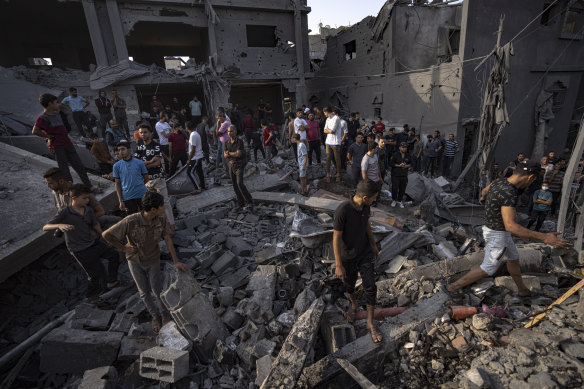 Palestinians look for survivors of the Israeli bombardment in the Maghazi refugee camp in the Gaza Strip.