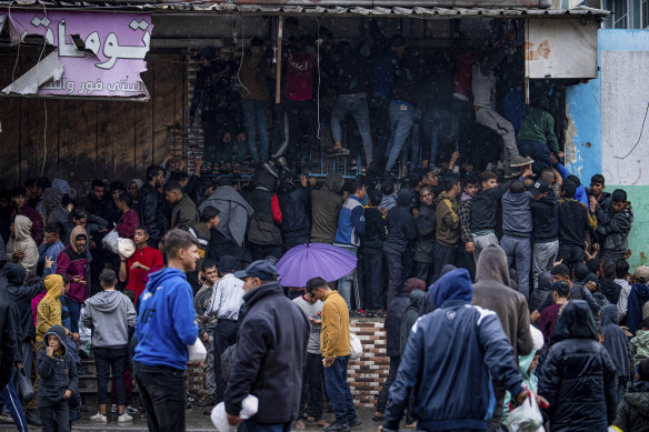 Palestinian crowds struggle to buy bread from a bakery in Rafah, Gaza Strip.