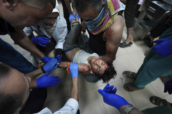 A Palestinian child wounded in the Israeli bombardment of the Gaza Strip is treated in a hospital in Deir al-Balah, on Monday.