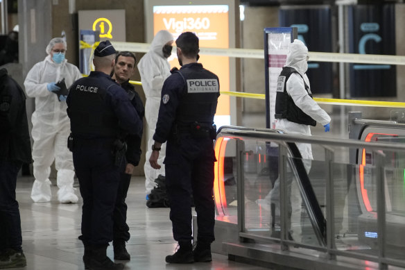 Police investigators work inside the Gare de Lyon station after the attack.
