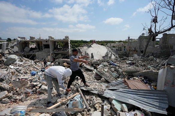 Residents on Wednesday search through the rubble of homes in the Lebanese village of Charnay after an Israeli airstrike.