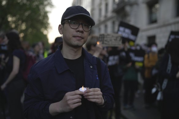 Hong Kong activist Nathan Law attends a candlelight vigil outside the Chinese embassy in London.